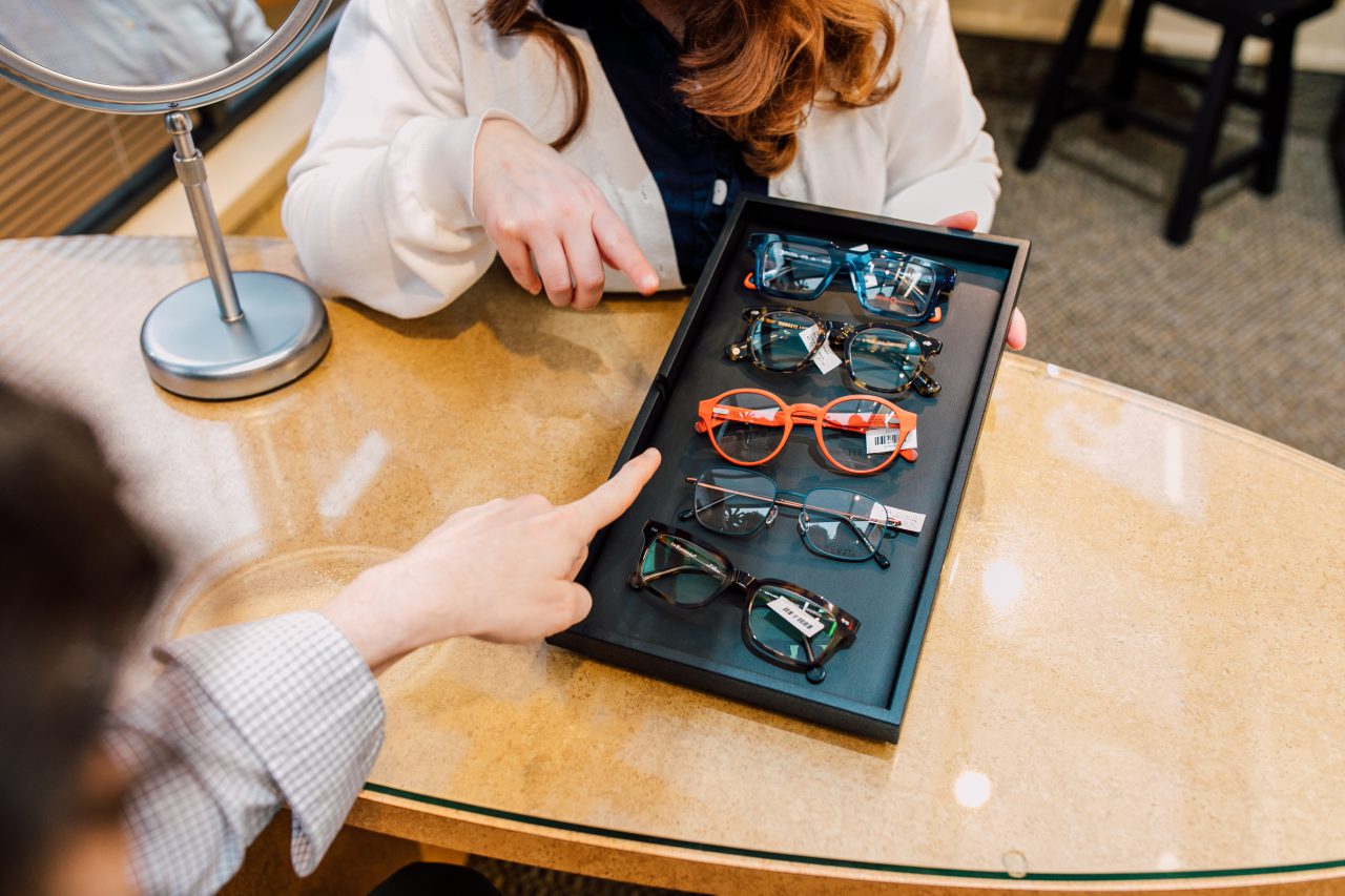 optician helps select glasses